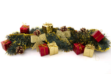 arrangement of Christmas decorations (gifts, tinsel, cones, ribbons) on a white backgroundの写真素材