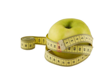 green apple wrapped measuring tape (white background)の写真素材