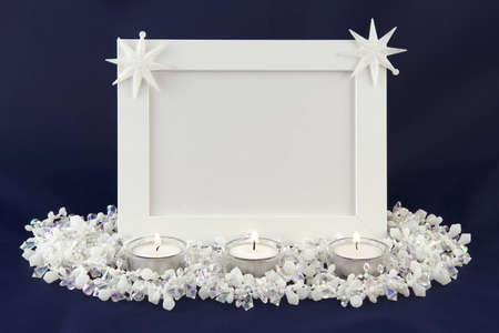White photo frame decorated with stars. front frame 3 candles. blue backgroundの写真素材