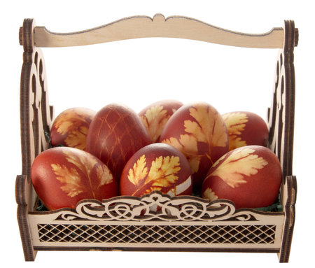 Easter eggs in a decorative basket on a white backgroundの写真素材