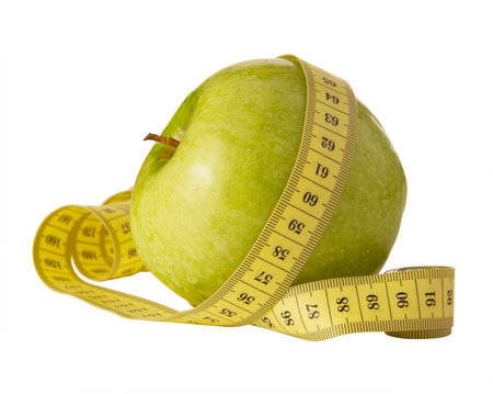 green apple and measuring tape on a white backgroundの写真素材