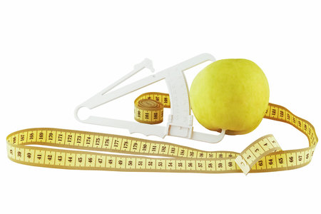 apple, meter and caliper on a white background (isolated object)の写真素材