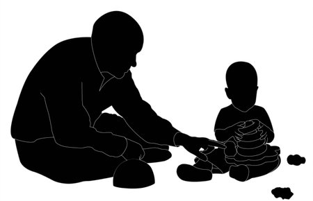 man and child collect pyramid sitting on the floor (silhouette)の写真素材