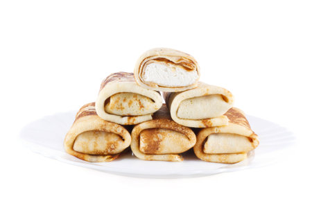 wrapped pancakes with cottage cheese on a plateの写真素材