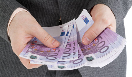 stack banknotes of 500 euro in male hands on a white backgroundの写真素材