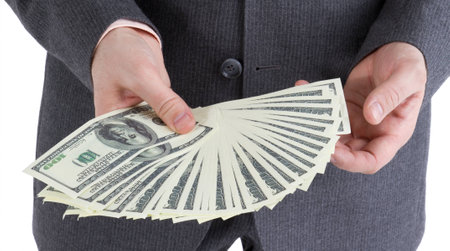 stack banknotes of 100 dollars in male hands on a white backgroundの写真素材