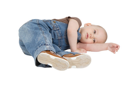 child is lying on the floor on a white backgroundの写真素材