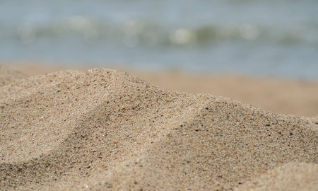 fragment of a sandy beach with the sea in the backgroundの写真素材