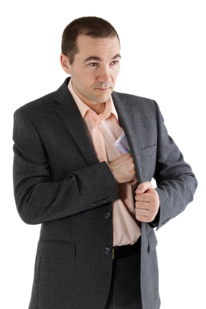 man puts a stack of banknotes in a pocket on a white backgroundの写真素材