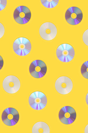 Retro-futuristic CD Pattern against yellow background.Vintage vibe ,minimal flat lay concept.