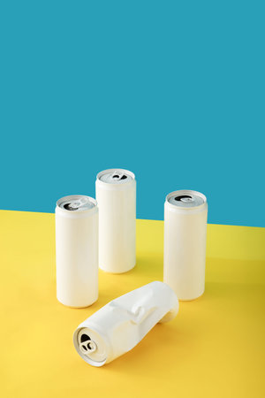 Four white cans against yellow-blue background with copy. Surrealism and retrofuturism in retro colors. Minimal vintage concept 80s , 90sの写真素材