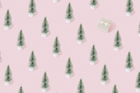 Christmas pattern with winter pine tree and gift box pastel pink background. Minimal new year concept.の写真素材