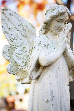 statue of an winged angel with her hands folded in prayer
