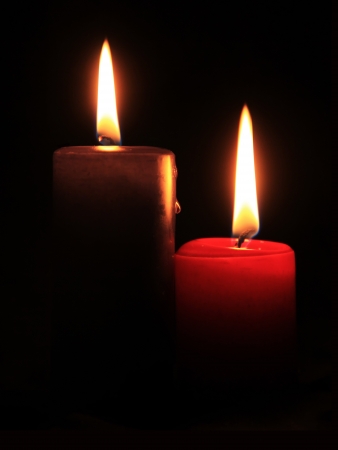 two candles on the black backgroundの写真素材