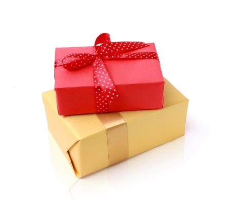 Gift holiday red and golden boxes group with bow on a white backgroundの写真素材