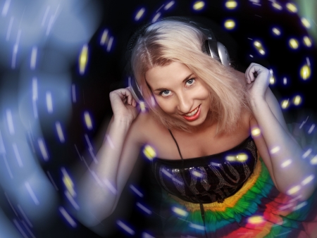 Women dj in headphones listening music isolated on a black backgroundの写真素材
