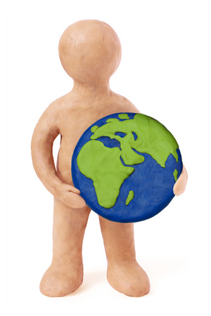 Plasticine man holding earth Europe Africa part on a white backgroundの写真素材
