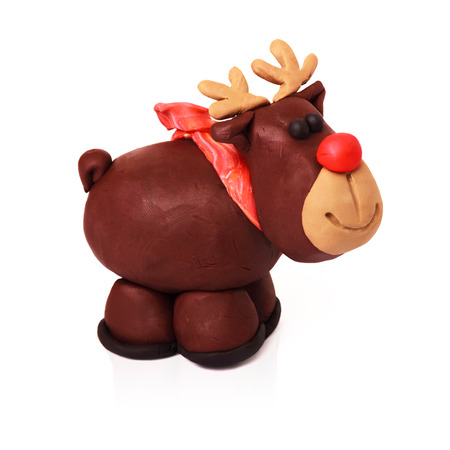 Plasticine cartoon deer with red scarf on a white backgroundの写真素材