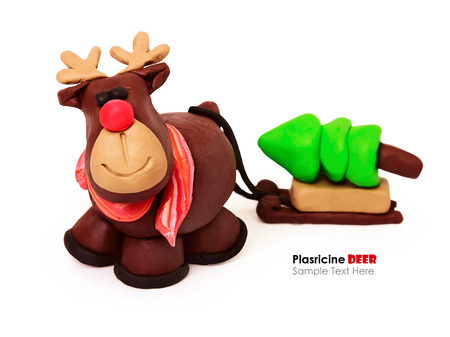 Plasticine cartoon deer with present cristmas tree on a white backgroundの写真素材