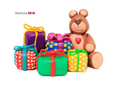 Plasticine chocolate happy bear whith gift holiday boxes on a white backgroundの写真素材