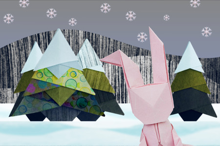 Paper origami selfie rabbit in winter christmas fir-tree in snow forestの写真素材