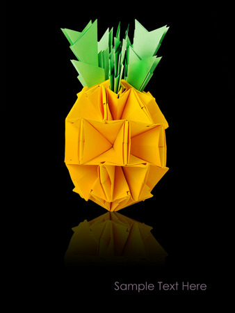 Origami paper pineapple yellow vitamin diet tropical fruit on a black backgroundの写真素材