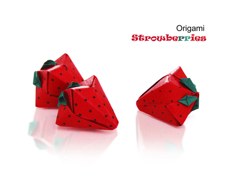 Origami sweet paper red isolated strawberries on a white reflection backgroundの写真素材
