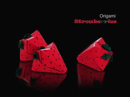 Origami sweet paper red isolated strawberries on a black reflection backgroundの写真素材