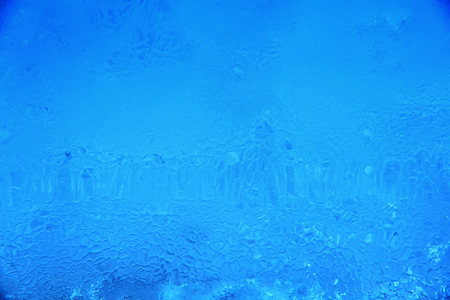 Textured ice dark blue frozen winter backgroundの写真素材