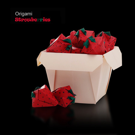 Origami sweet paper red isolated strawberries in basket on a black reflection backgroundの写真素材