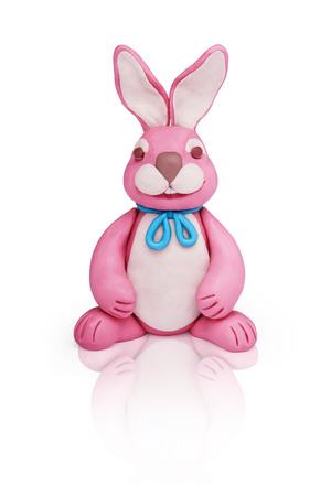 Easter pink plasticine bunny rabbit on a white mirror backgroundの写真素材
