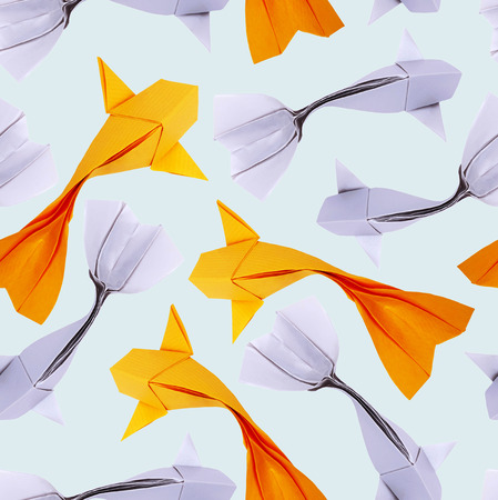 Origami paper goldfish and silver on a blue water background patternの写真素材