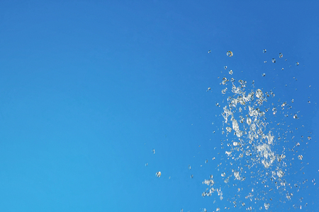Water blue liquid splash on a blue backgroundの写真素材