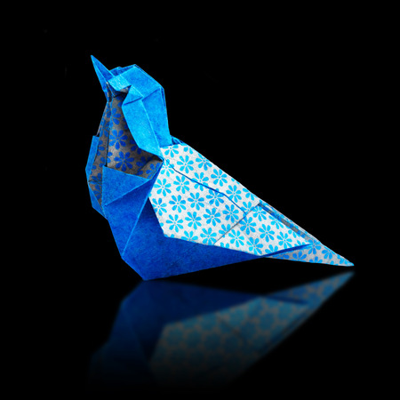 Origami art blue and bronze metalic floral bohemia pattern paper bird on a black backgroundの写真素材