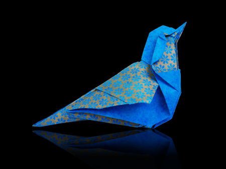 Origami art blue and bronze metallic floral bohemia pattern paper bird on a black backgroundの写真素材
