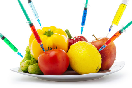 Toxic gmo vegetables modification syringe isolated on a white backgroundの写真素材