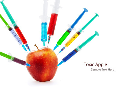 Toxic gmo apple fruit modification syringe isolated on a white backgroundの写真素材