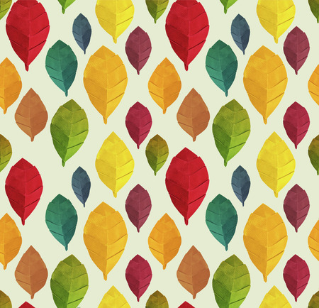 Origami autumn paper red yellow green leaves pattern isolated on a green backgroundの写真素材