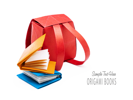 School red backpack with education books origami set on a white backgroundの写真素材