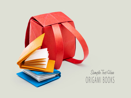 School red backpack with education books origami set on a gray backgroundの写真素材