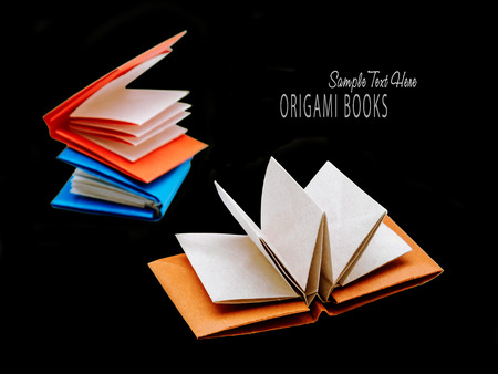 Origami education opened paper books on a black backgroundの写真素材