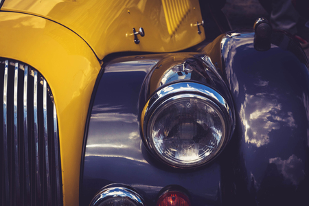 Antique vintage retro yellow and blue automobile bumper car front lightの写真素材