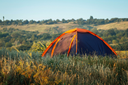Travel summer orange gray tent tourism with sun lightの写真素材