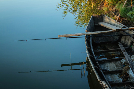 Lake holiday fishing rod and olad boat summer travel hobbyの写真素材