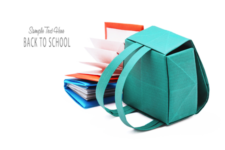 School backpack with education books origami set on a white backgroundの写真素材