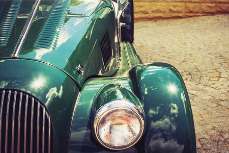 Antique vintage retro green automobile bumper car front light isolated on white backgroundの写真素材