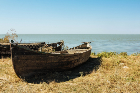 Lake holiday fishing old boat summer sunrice on waterの写真素材