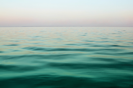 Lake tranquil sun rice landscape above water wavesの写真素材