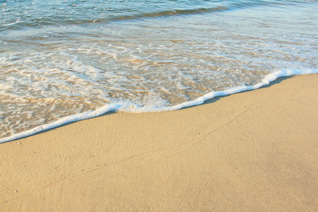 Sand golden beach with blue wave blank backgroundの写真素材