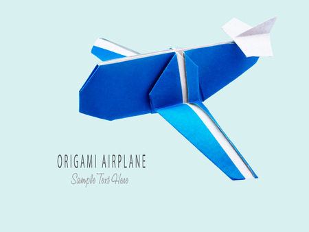 Origami blue cartoon paper travel isolated airplane on blue backgroundの写真素材